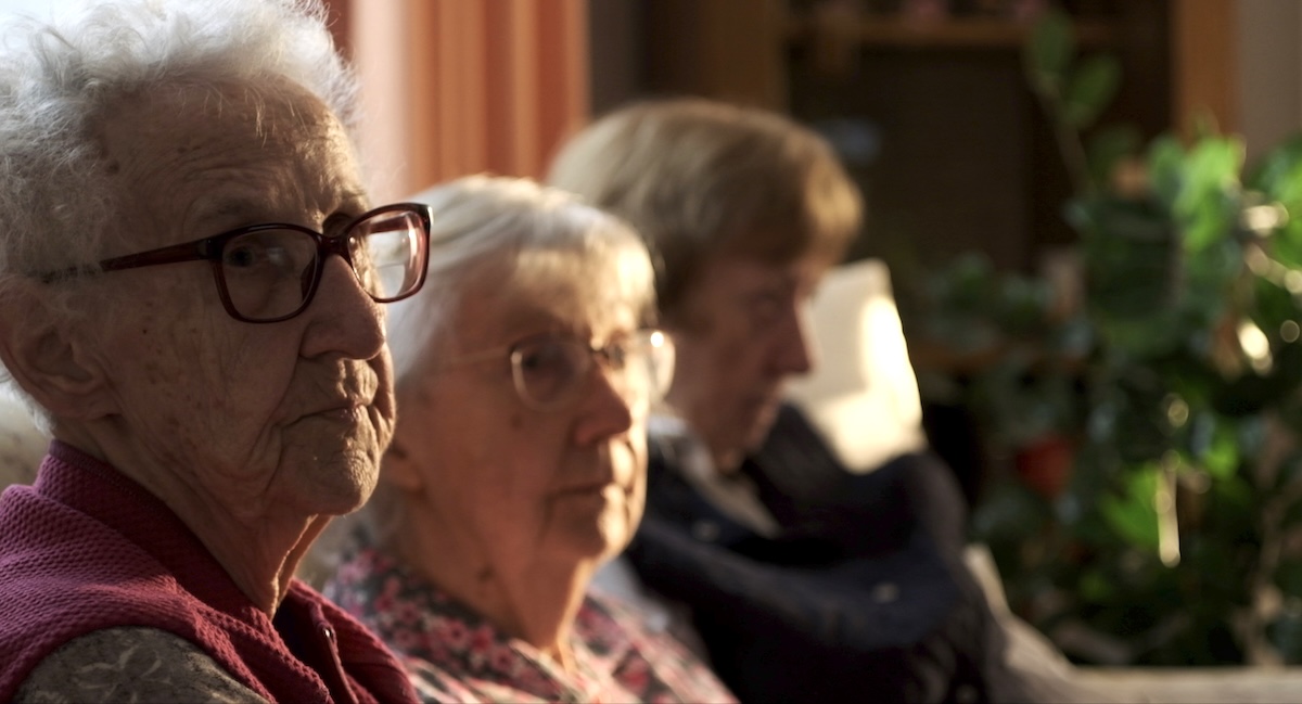three sisters in the age from 83 to 94 sit on the sofa