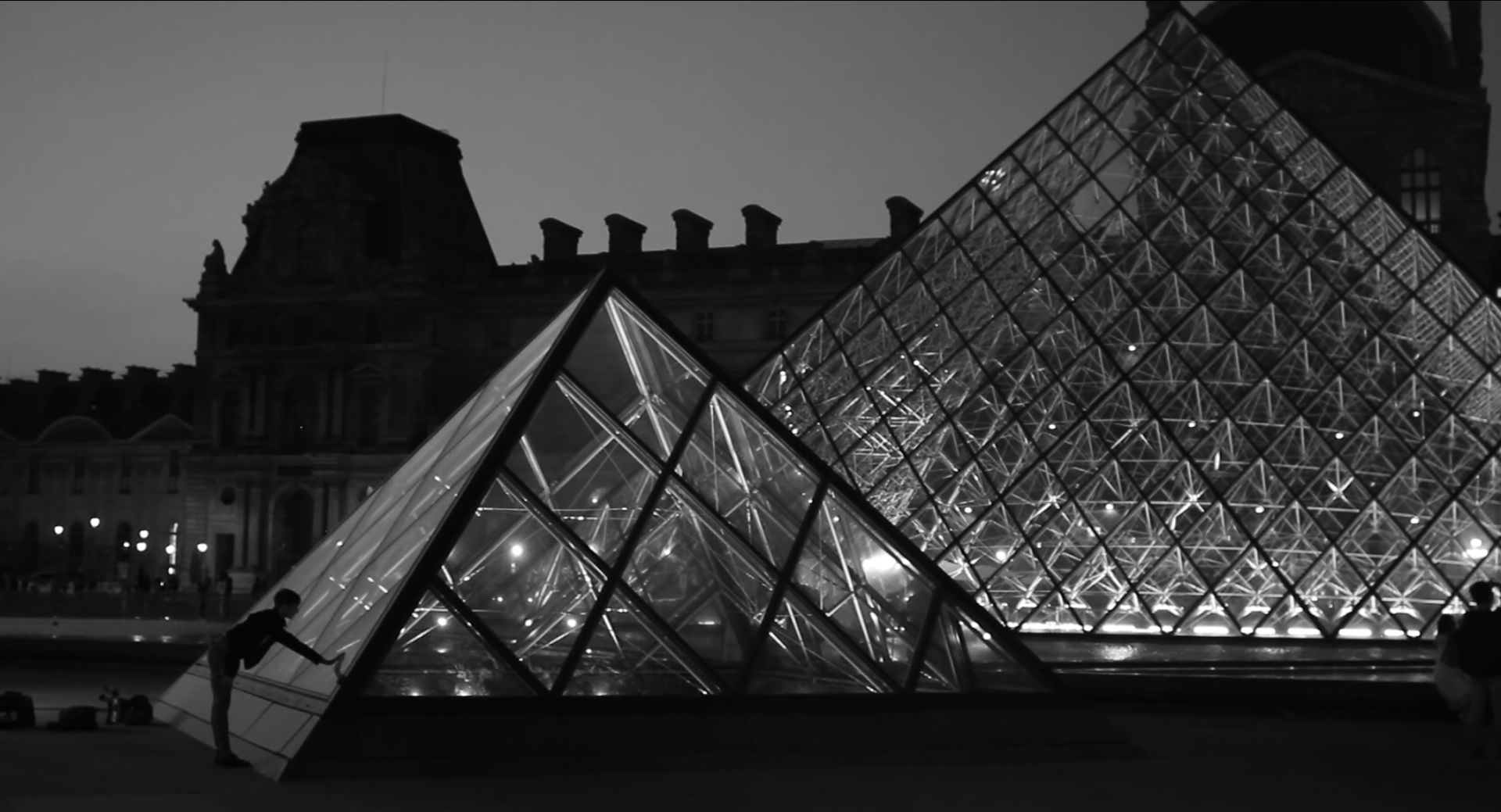 a creature touches the facade of the Louvre